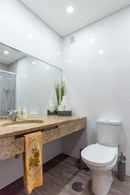 a bathroom with a toilet and a sink and a mirror at Avenida Apartment by MP in Vila Nova de Gaia