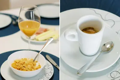 a glass of wine and a bowl of cereal and a cup of coffee at PortoVivo Bonjardim Apartamento in Porto