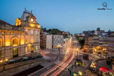 a city street with a clock tower and a building at Locally Yours São Bento Apartments in Porto
