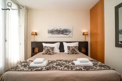 a bedroom with a large bed with two pillows at Locally Yours São Bento Apartments in Porto