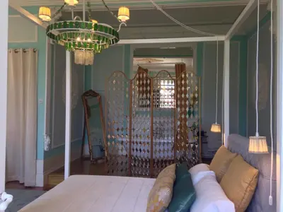 a living room with a couch and a chandelier at Boavista Eco-Luxury House in Porto