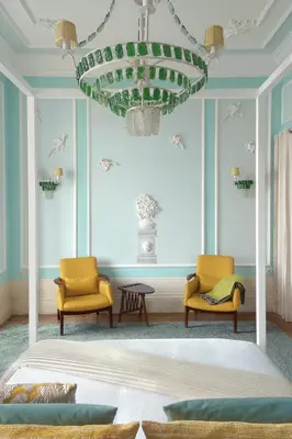 a bedroom with two chairs and a bed and a chandelier at Boavista Eco-Luxury House in Porto
