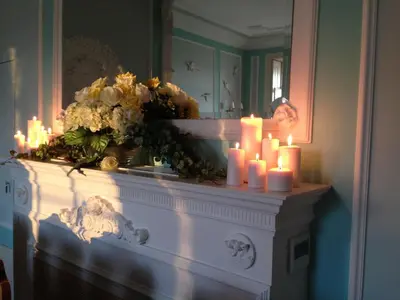 a bunch of candles on a mantle with flowers at Boavista Eco-Luxury House in Porto