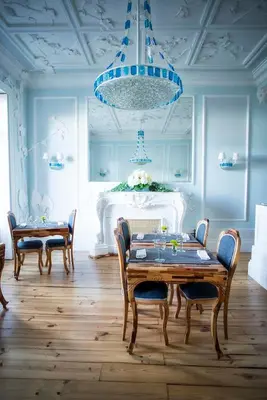 a dining room with a table and chairs and a blue ceiling at Boavista Eco-Luxury House in Porto