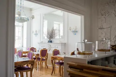 a dining room with tables and purple chairs at Boavista Eco-Luxury House in Porto