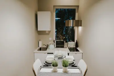 a small kitchen with a table and chairs and a window at Five Seven Nine Apartments in Porto