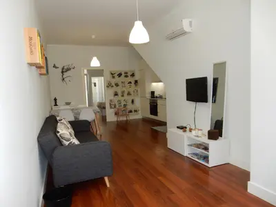 a living room with a couch and a television at Oporto Downtown Apartment in Porto