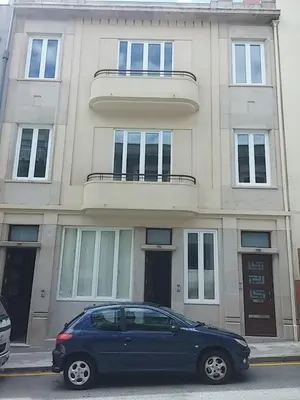 a blue car parked in front of a building at Oporto Downtown Apartment in Porto