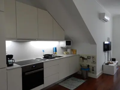 a kitchen with white cabinets and a stove top oven at Oporto Downtown Apartment in Porto