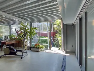 a large room with a treadmill and a desk in a building at Garden House in Porto
