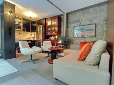 a living room with a white couch and a table at Garden House in Porto