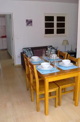 a wooden dining room table with chairs and plates on it at The Yellow House in Vila Nova de Gaia