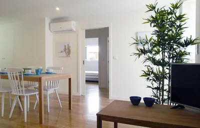 a dining room with a table and a tv at Spot Apartments Ceuta in Porto