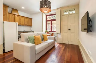 a living room with a couch and a kitchen at Discovery | Porto-Flores in Porto