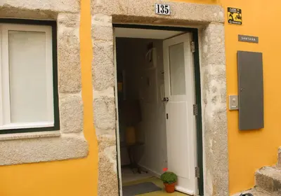 an open door of a building with a window at Arco Apartments in Porto