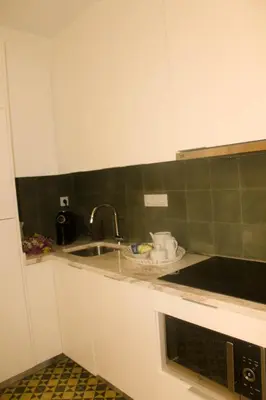 a kitchen with a sink and a microwave at Arco Apartments in Porto