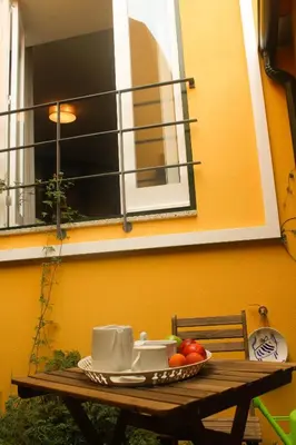 a table with a plate of fruit and a window at Arco Apartments in Porto
