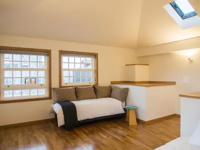 a bedroom with a bed and two windows at Belomont6 Apartments in Porto