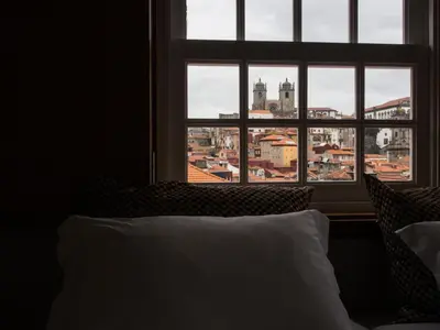 a bedroom with a view of a city from a window at Belomont6 Apartments in Porto