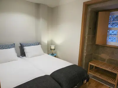 a bedroom with a white bed and a window at Belomont6 Apartments in Porto