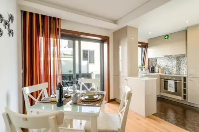 a kitchen and dining room with a white table and chairs at Merc Porto Santa Catarina in Porto