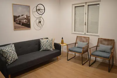 a living room with a couch and two chairs at T2P Félix House in Vila Nova de Gaia
