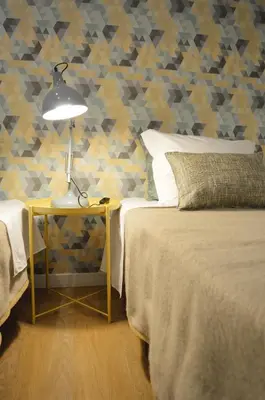 a bedroom with a bed and a table with a lamp at T2P Félix House in Vila Nova de Gaia