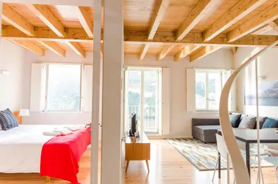 a bedroom with a bed and a living room at Oporto Trendy River in Porto