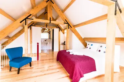 a bedroom with a bed and a blue chair at Oporto Trendy River in Porto