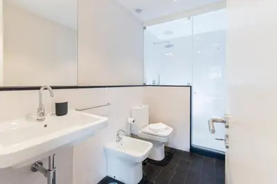 a white bathroom with a sink and a toilet at Oporto Trendy River in Porto