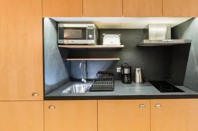 a kitchen with a sink and a microwave at Oporto Trendy River in Porto