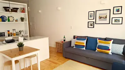 a living room with a couch and a table at Flowers Center in Porto