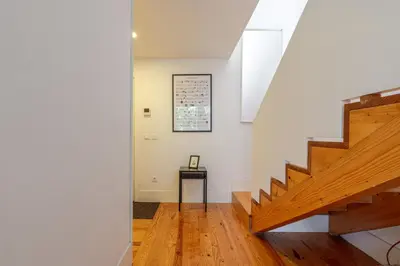 a hallway with stairs and a picture on the wall at Apartamento City Center in Porto
