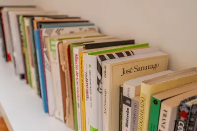 a row of books sitting on a shelf at Apartamento City Center in Porto