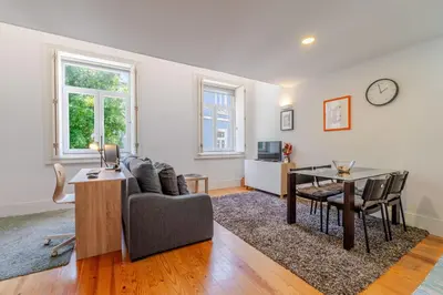 a living room with a couch and a table at Apartamento City Center in Porto