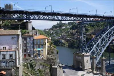 a bridge over a river with houses and buildings at Porto Riverside in Porto
