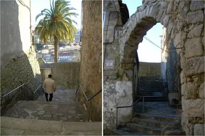 a man walking down a stone stairs with a palm tree at Porto Riverside in Porto