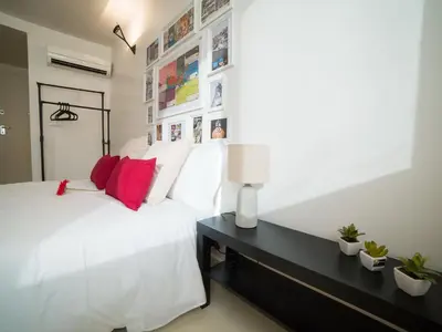 a bedroom with a white bed and a black desk at OPORTO GUEST - Cedofeita in Porto