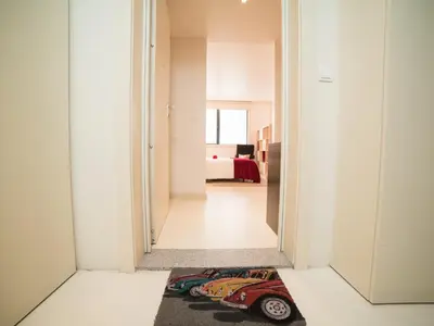 a hallway leading to a bedroom with a rug on the floor at OPORTO GUEST - Cedofeita in Porto
