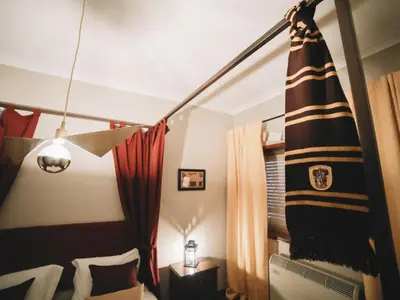 a bedroom with a bed and curtains and a lamp at OPORTO GUEST Harry Potter flat with Parking in Porto