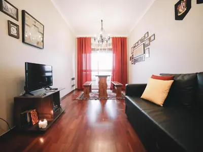 a living room with a couch and a television at OPORTO GUEST Harry Potter flat with Parking in Porto
