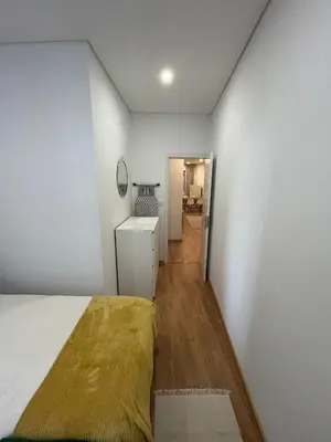 a bedroom with a bed and a white wall at Down Bonjardim Apartments in Porto