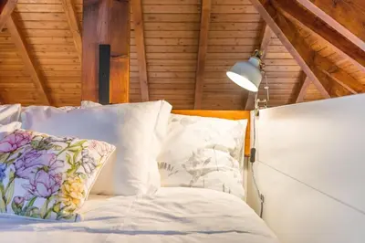 a bed with white pillows and a lamp at Home in Porto - Cozy 2BR Duplex by LovelyStay in Porto