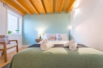 a bedroom with a bed with towels on it at Home in Porto - Cozy 2BR Duplex by LovelyStay in Porto