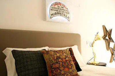 a bedroom with a bed with a pillow and a lamp at Oporto Chic&Cozy - Batalha in Porto