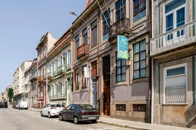 a city street with cars parked in front of buildings at Gardenia Urban Retreat in Porto