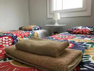 a room with two twin beds and a window at Casa Devesas in Vila Nova de Gaia