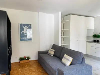 a living room with a couch and a kitchen at Casa Devesas in Vila Nova de Gaia