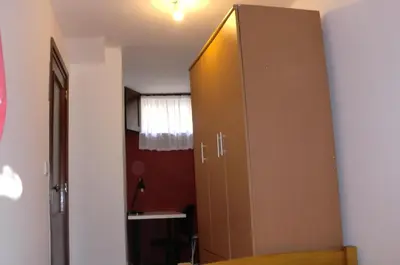 a large cabinet in the corner of a room at The Yellow House 3 in Porto
