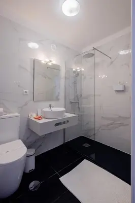 a bathroom with a toilet and a sink and a shower at Music House 3 bedroom Apt w garage in Porto
